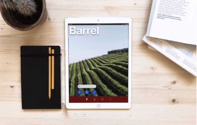 Desktop with books, notepads and iPad displaying login screen of Angel City Data's Barrel app.